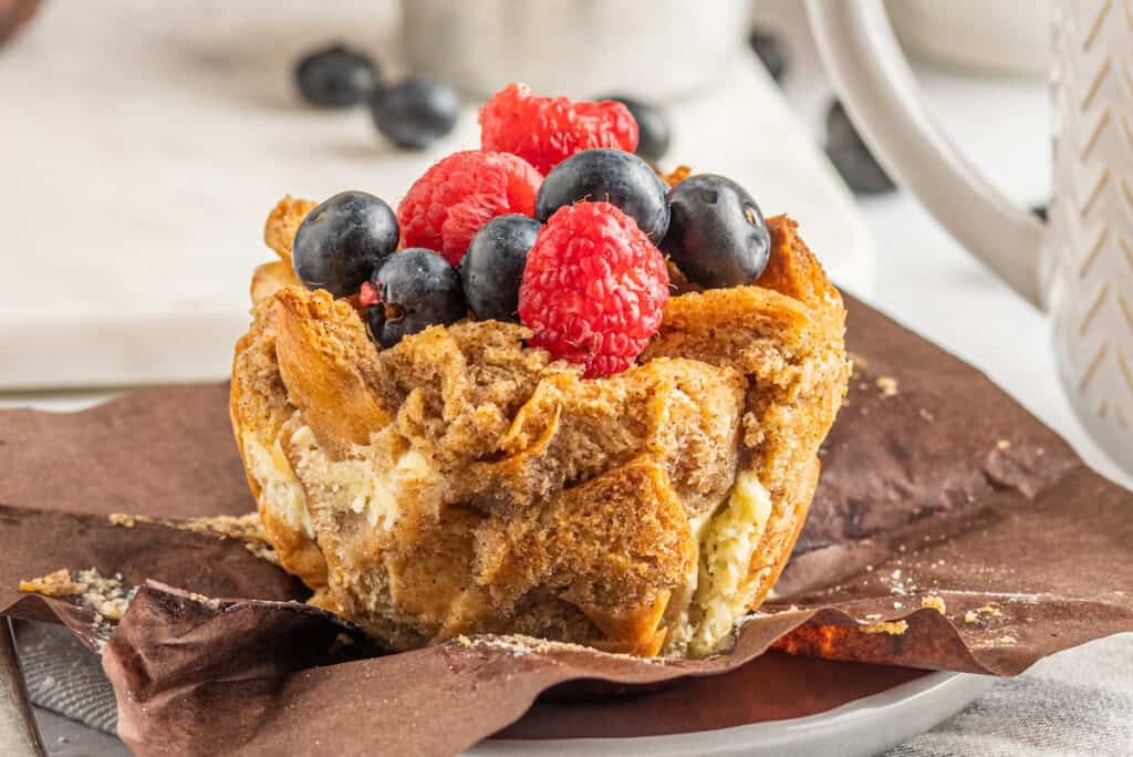 one French toast muffin unwrapped with berries on top