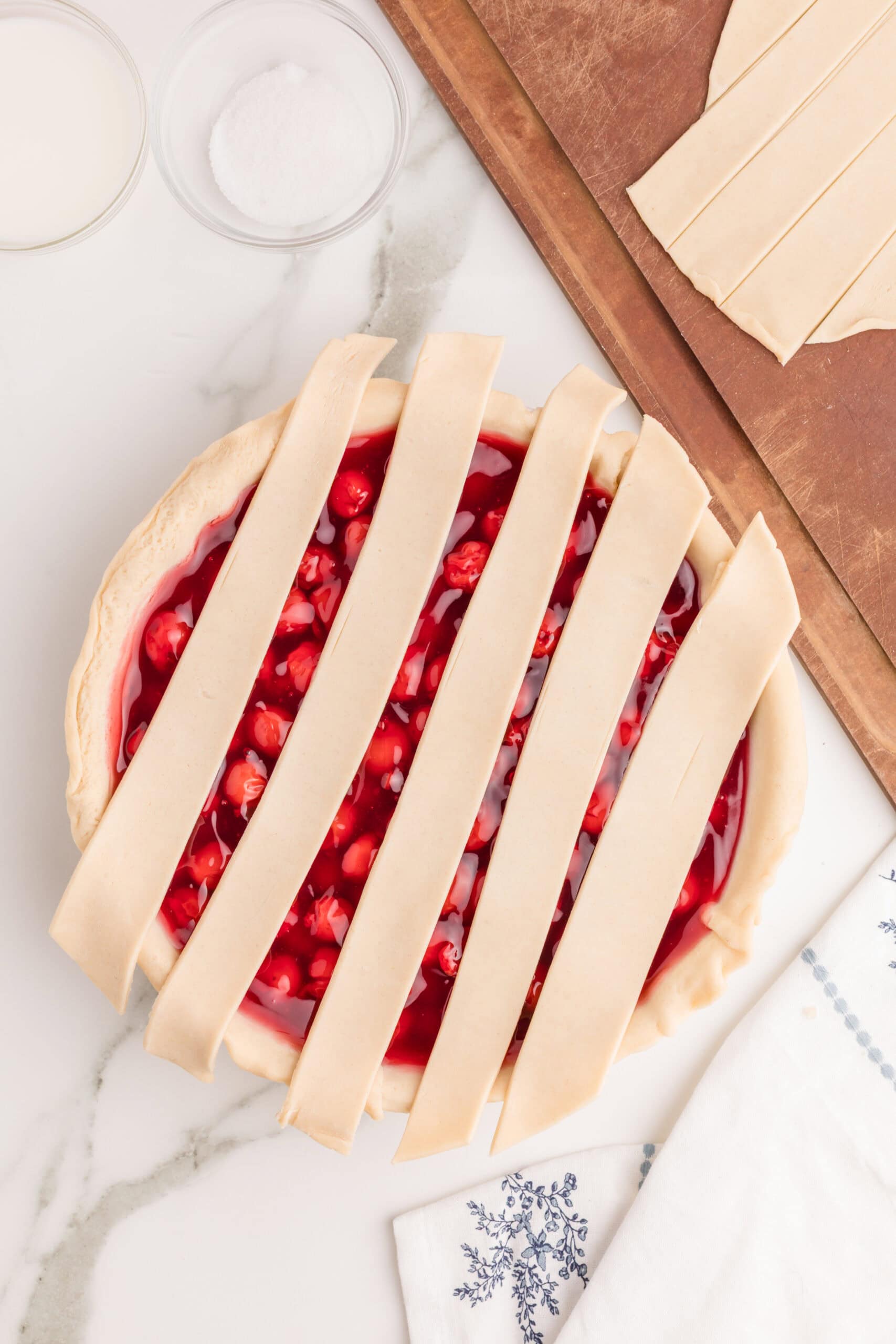 Unbaked cherry pie with lattice crust ready for baking.