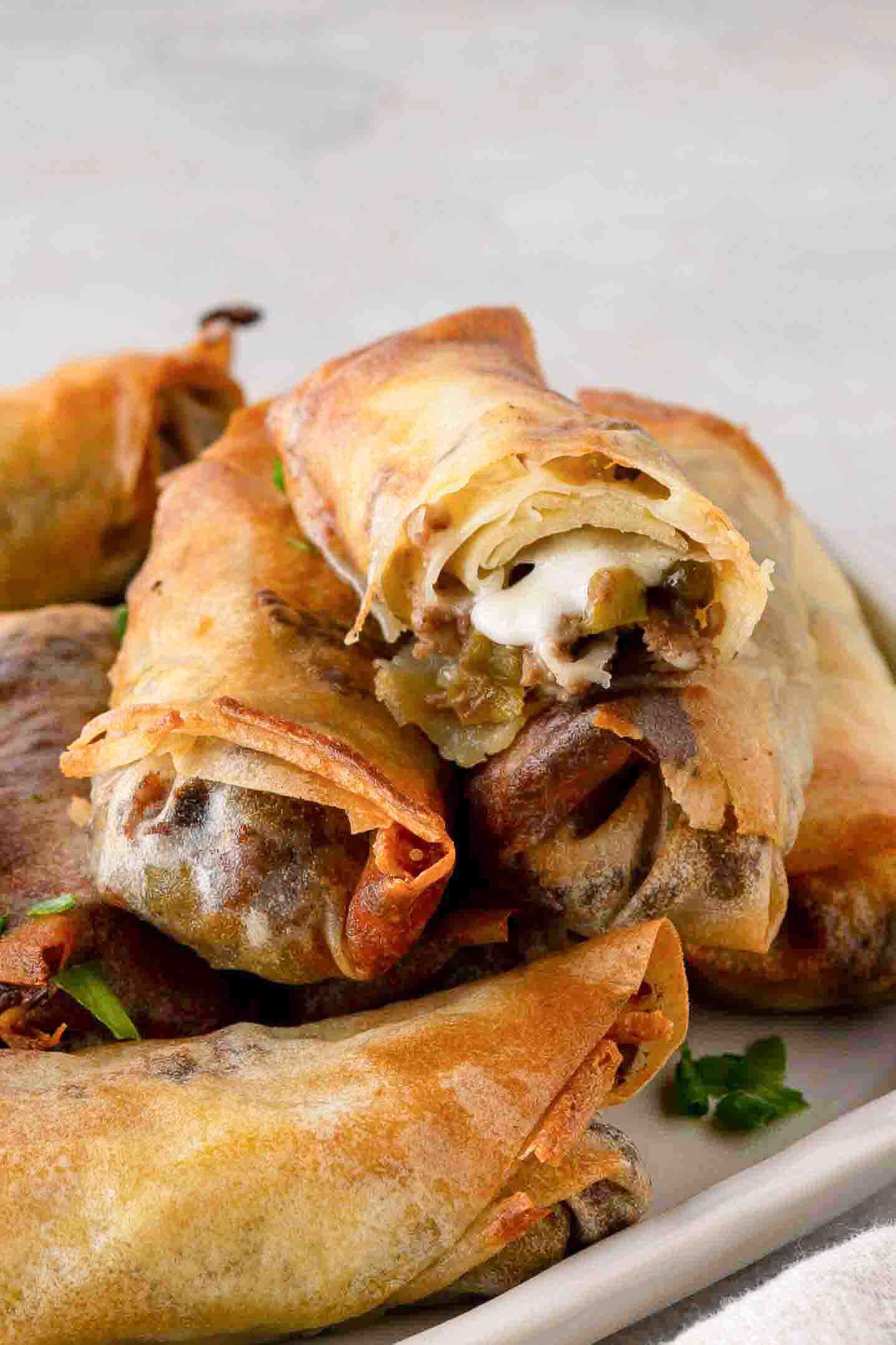 Plated cheese steak egg rolls ready to be enjoyed