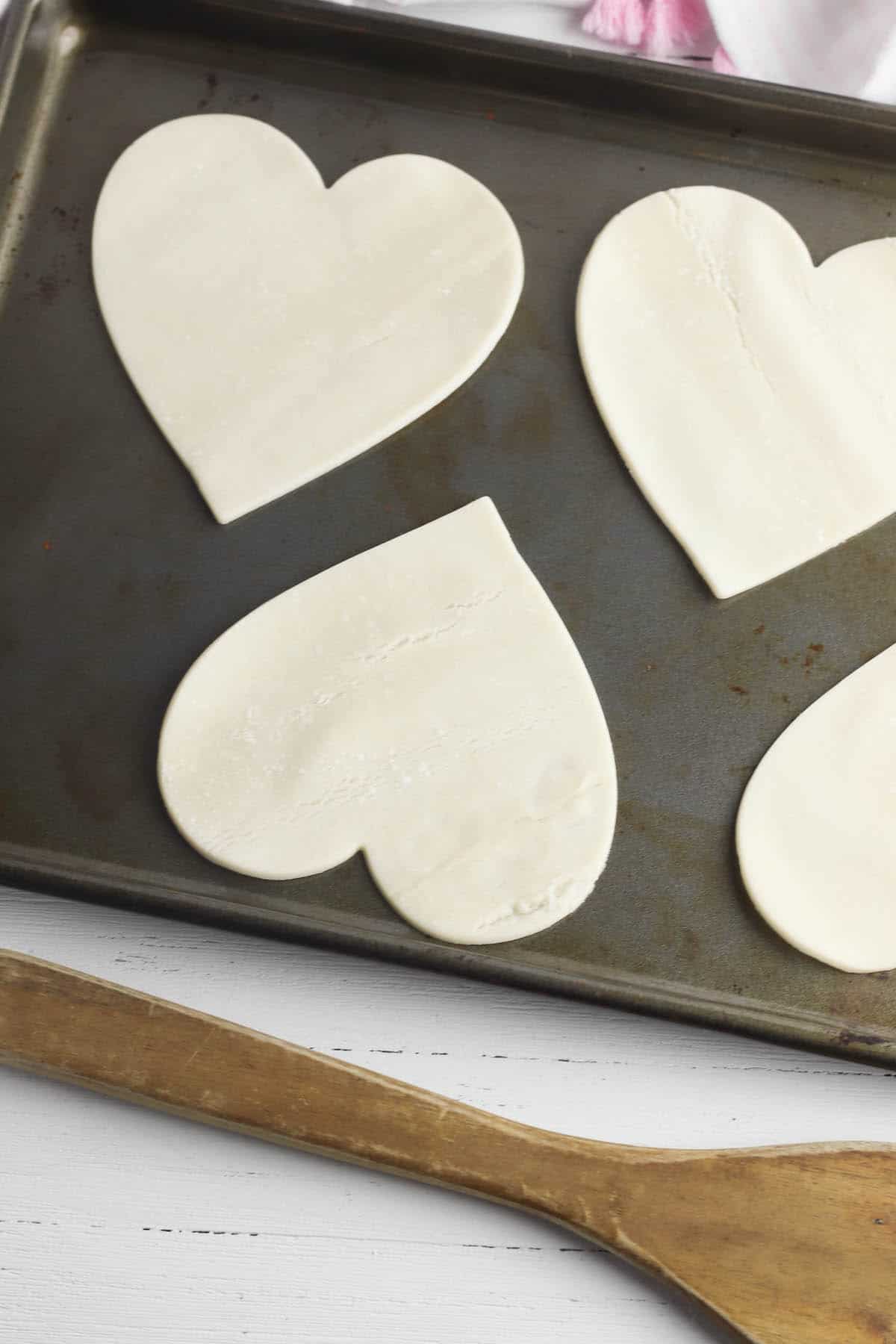 heart shaped pie crust on a baking sheet