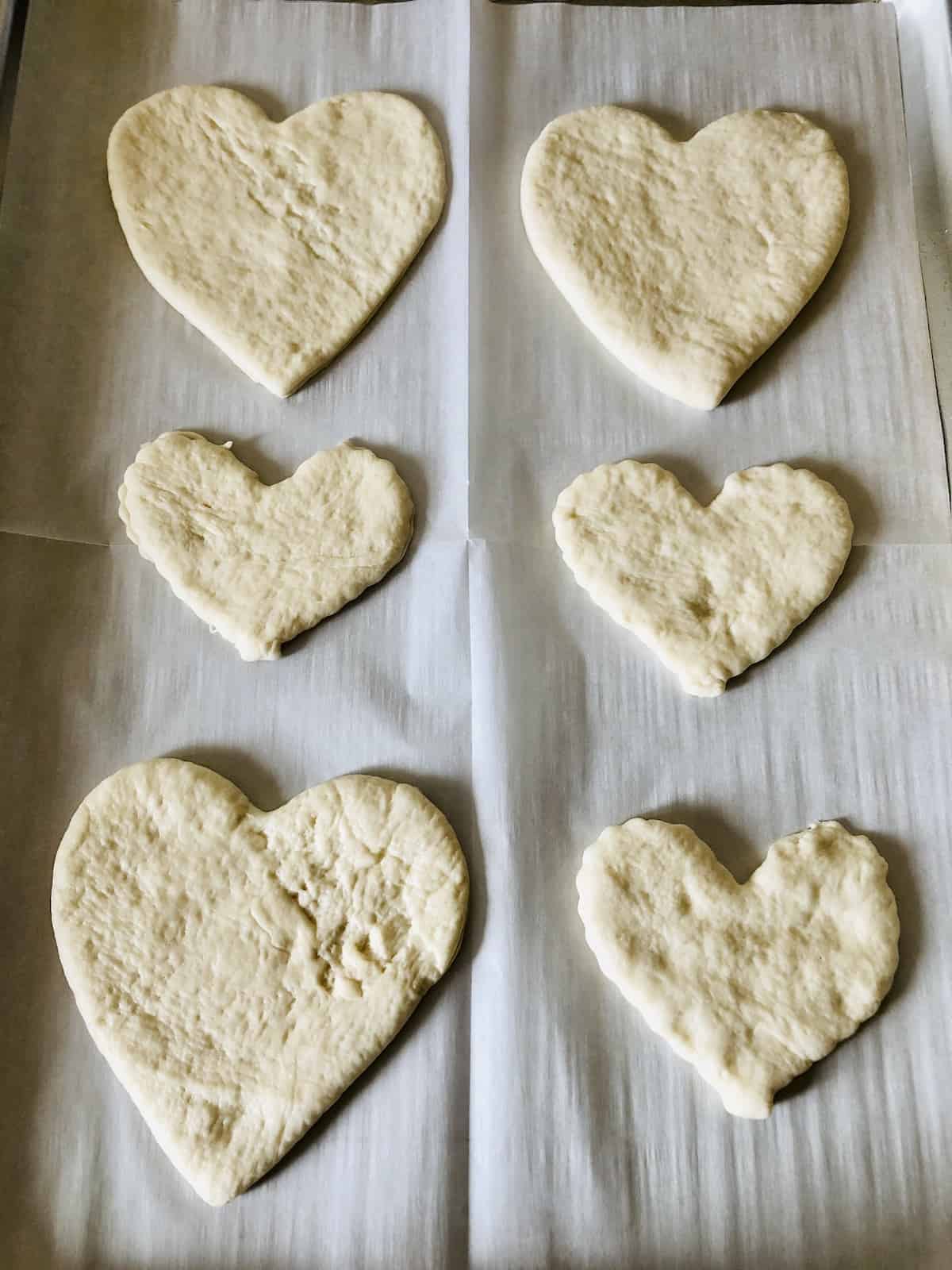 six pizza dough hearts