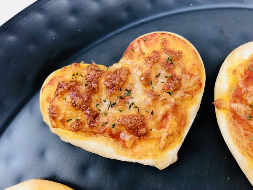 one heart shaped mini cheese pizza