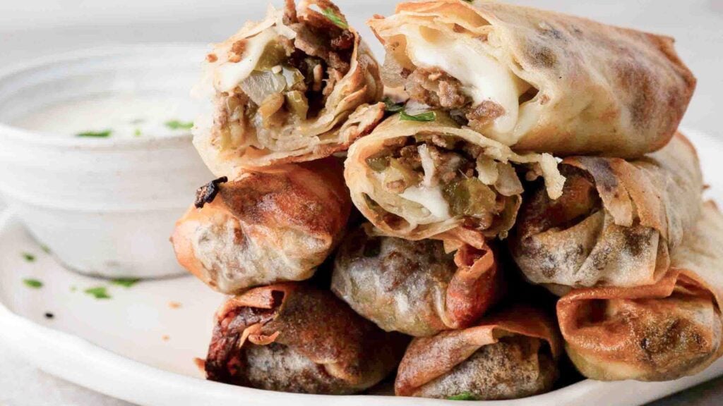 Philly Cheese Steak Egg rolls piled high on plate, ready to be enjoyed
