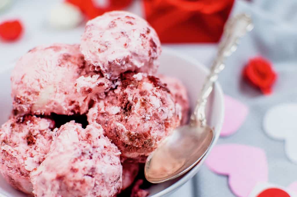 a bowl of red velvet ice cream with a spoon