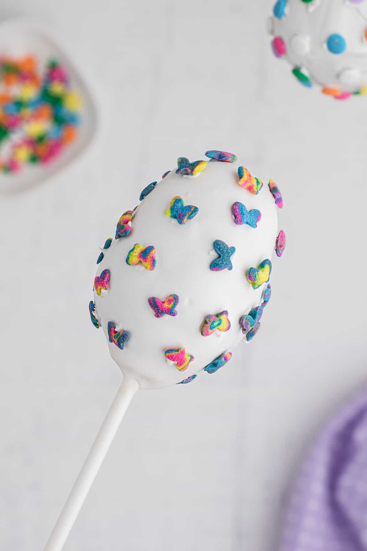 use extra candy melts to attach sprinkles to the cake pop