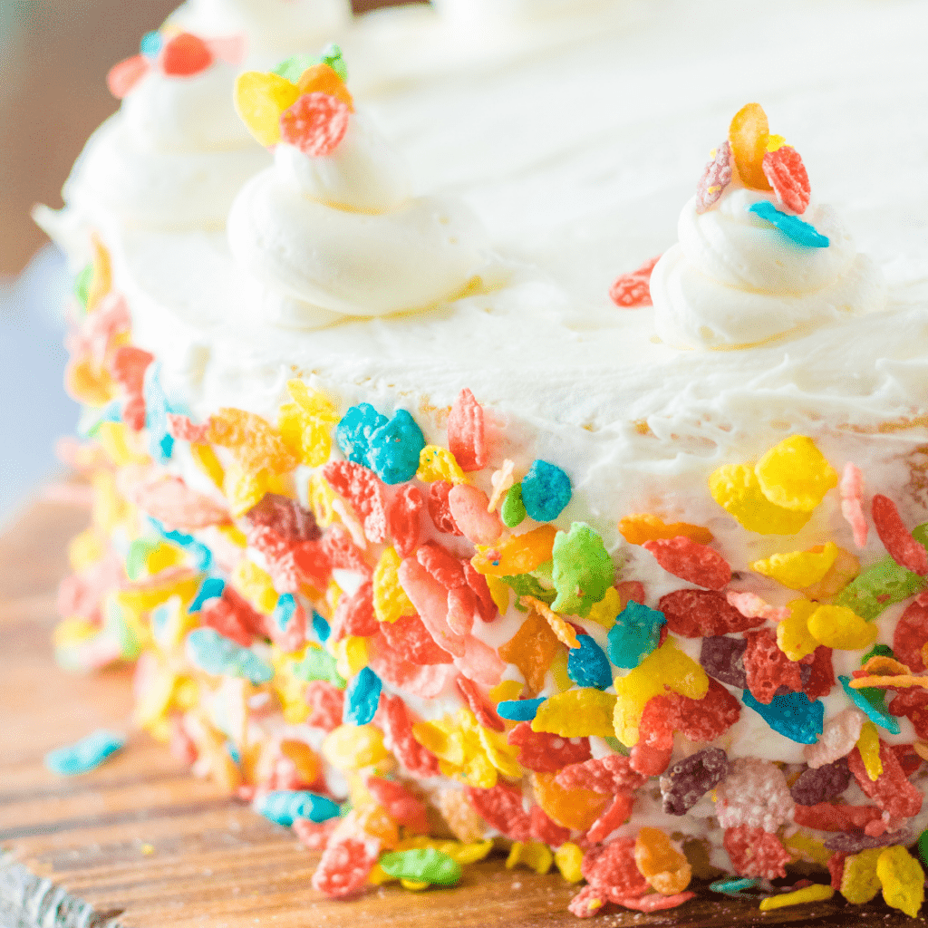 Fruity Pebbles Cake on a wooden cutting board