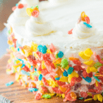Fruity Pebbles Cake on a wooden cutting board