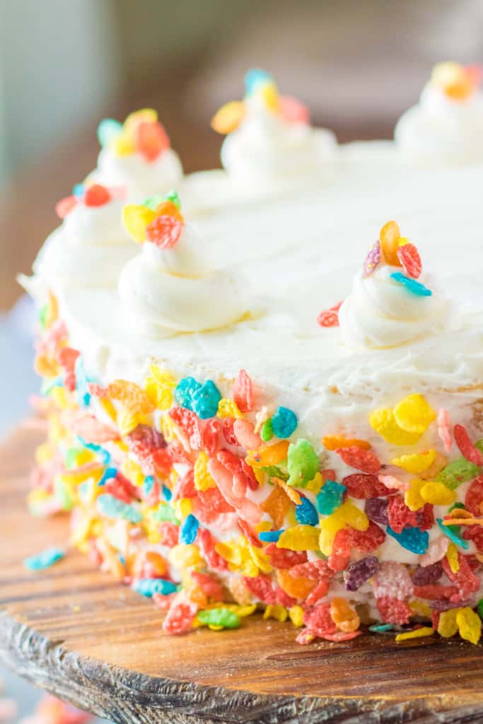 Fruity Pebbles cake on a wooden cutting board