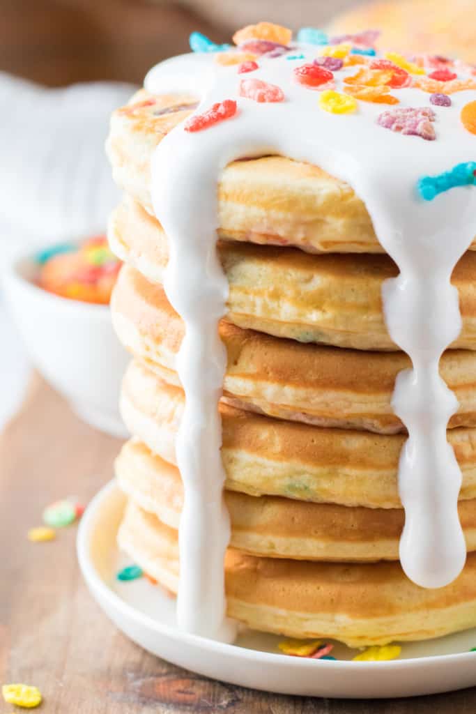 stack of Fruity Pebbles pancakes with marshmallow fluff dripping down the side