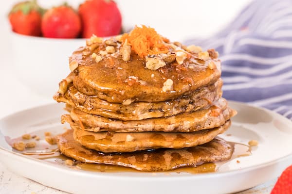 a tall stack of carrot cake pancakes