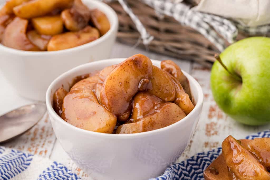 a white dish full of fried apples