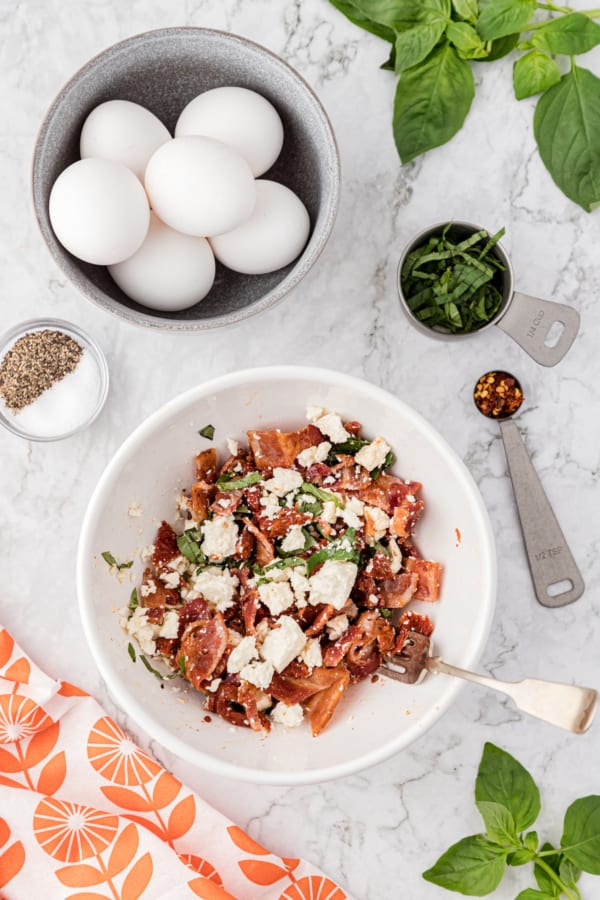 mix the bacon, sun-dried tomatoes, basil, and feta in a medium bowl