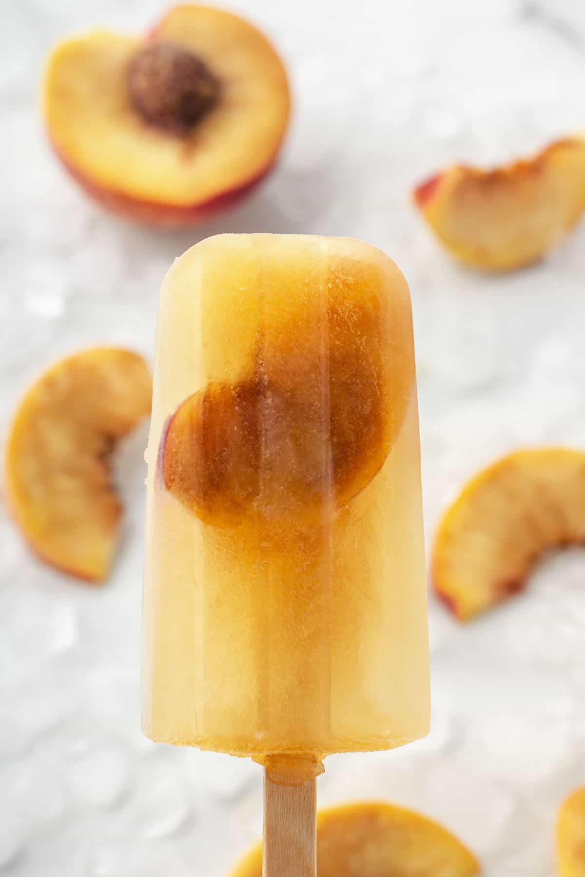 a close up of one Homemade Sweet Tea Peach Popsicles
