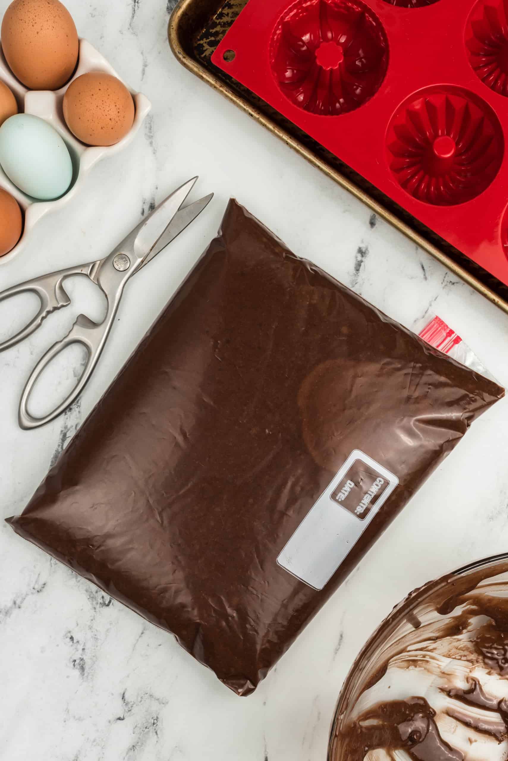 chocolate brownie batter mixture in a zippered plastic bag