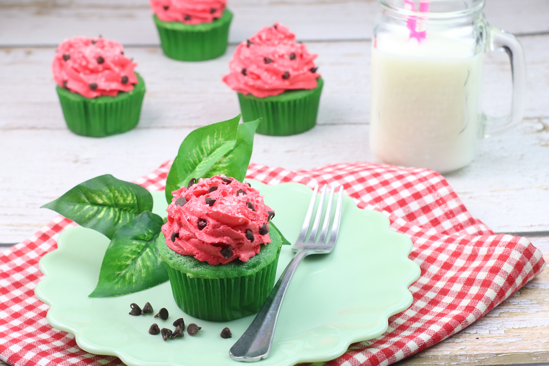 watermelon cupcakes with watermelon frosting and a fork