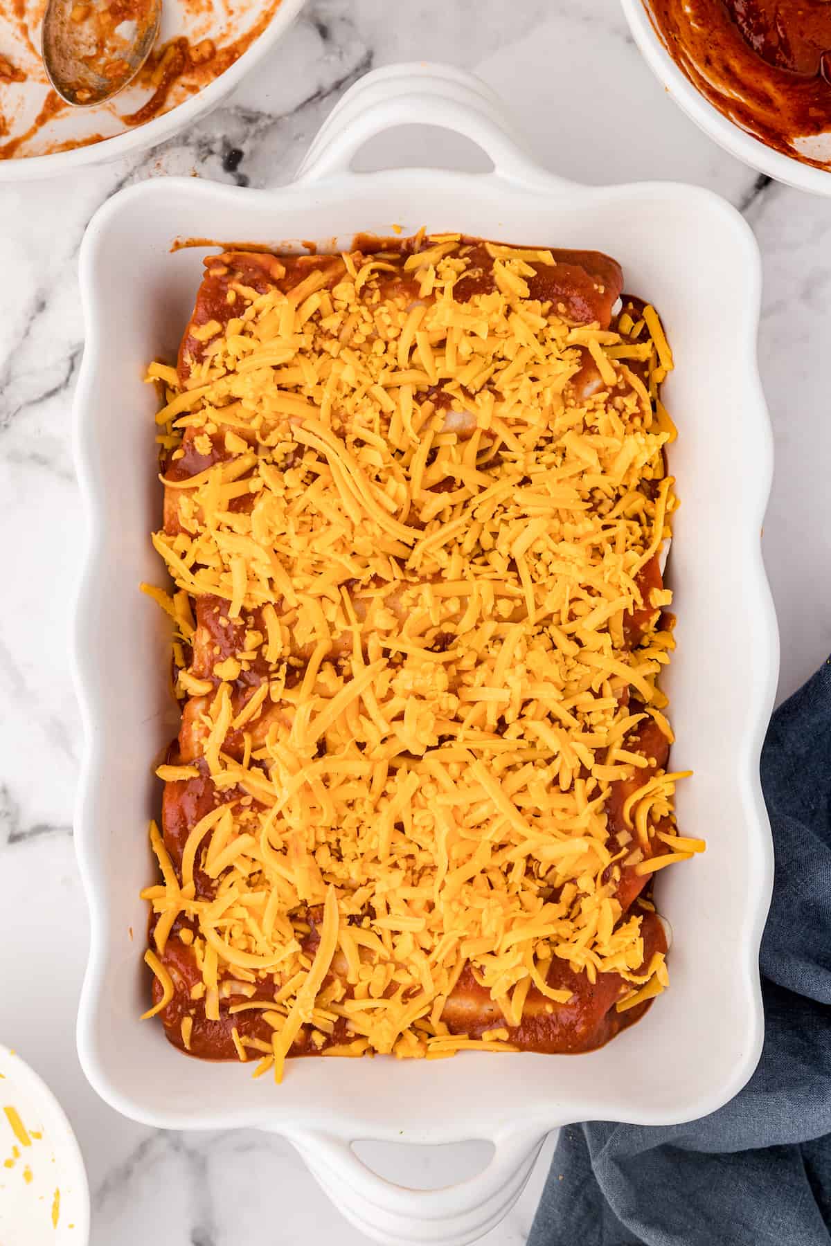 sprinkle the BBQ chicken enchiladas with shredded cheese