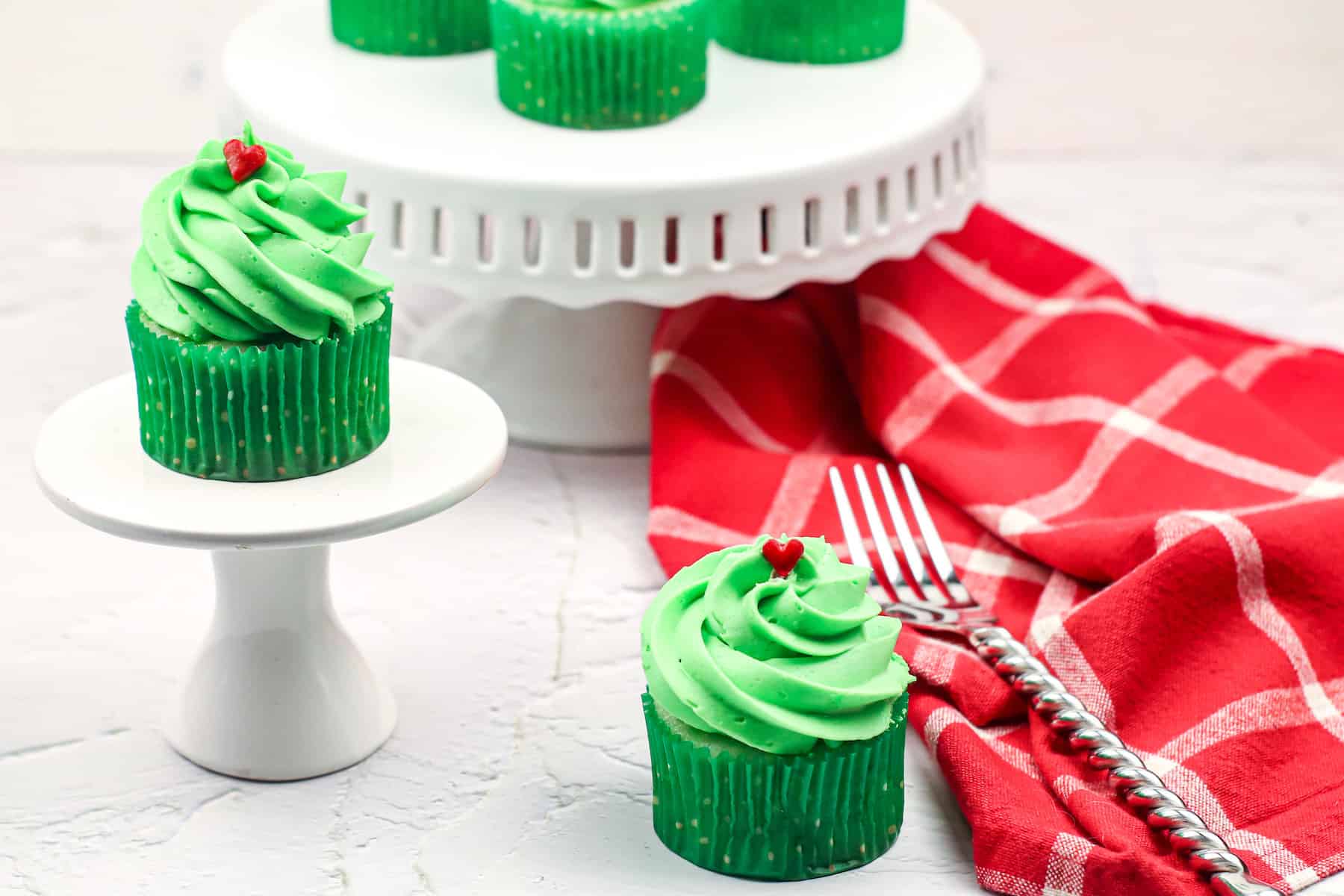 one green Grinch pistachio flavored cupcake on a table