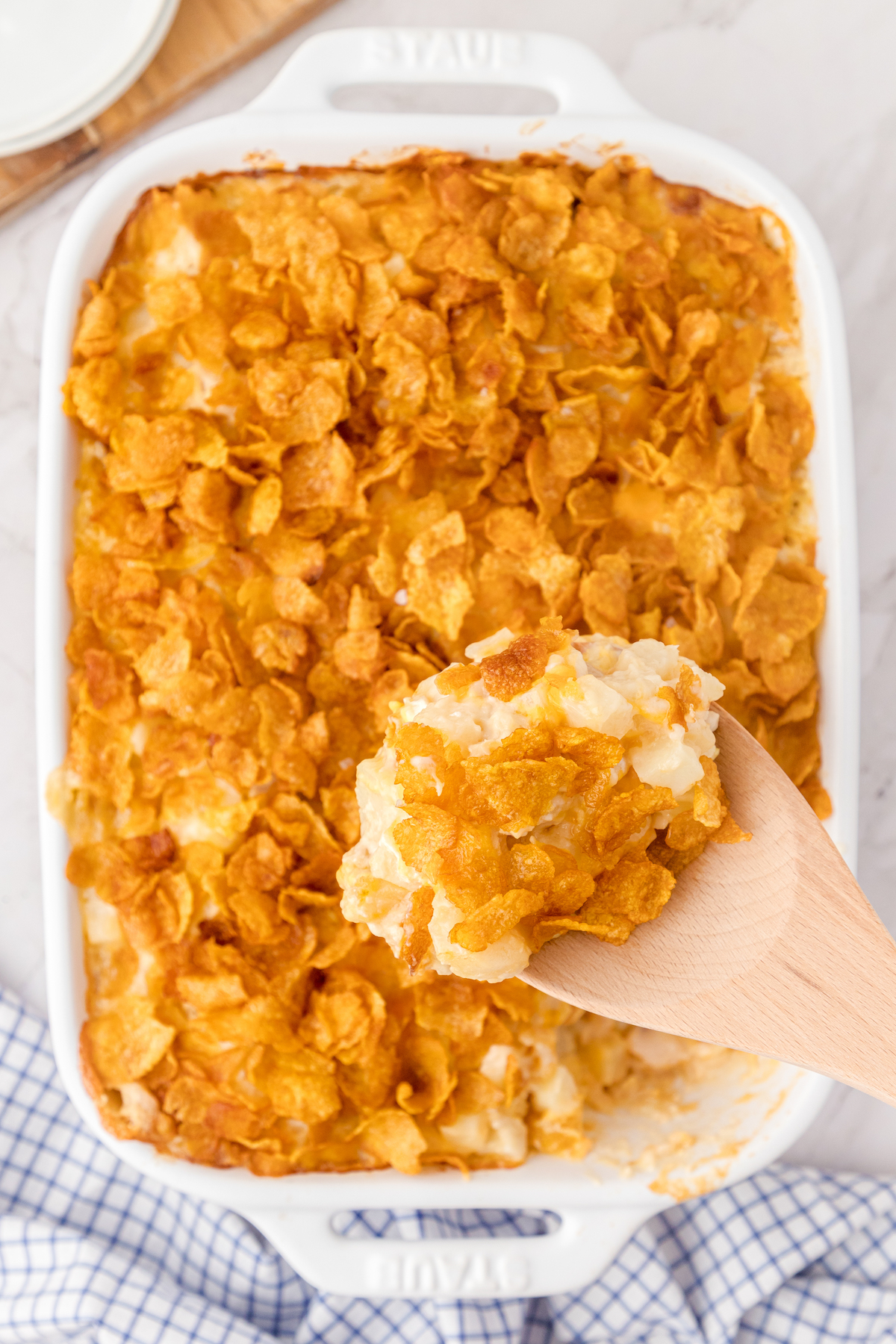 cheesy chicken hashbrown casserole in a white baking dish