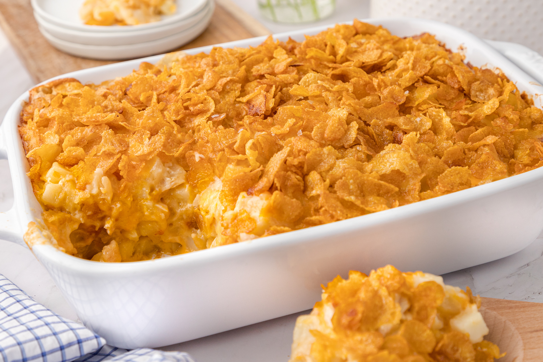 cheesy chicken hashbrown casserole in a white baking dish