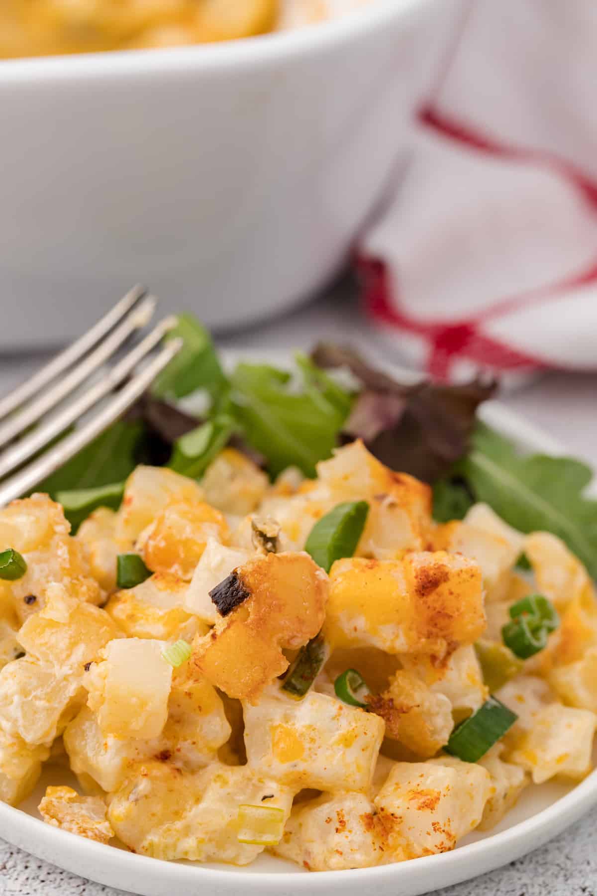 one serving of healthy hashbrown casserole on a small white plate