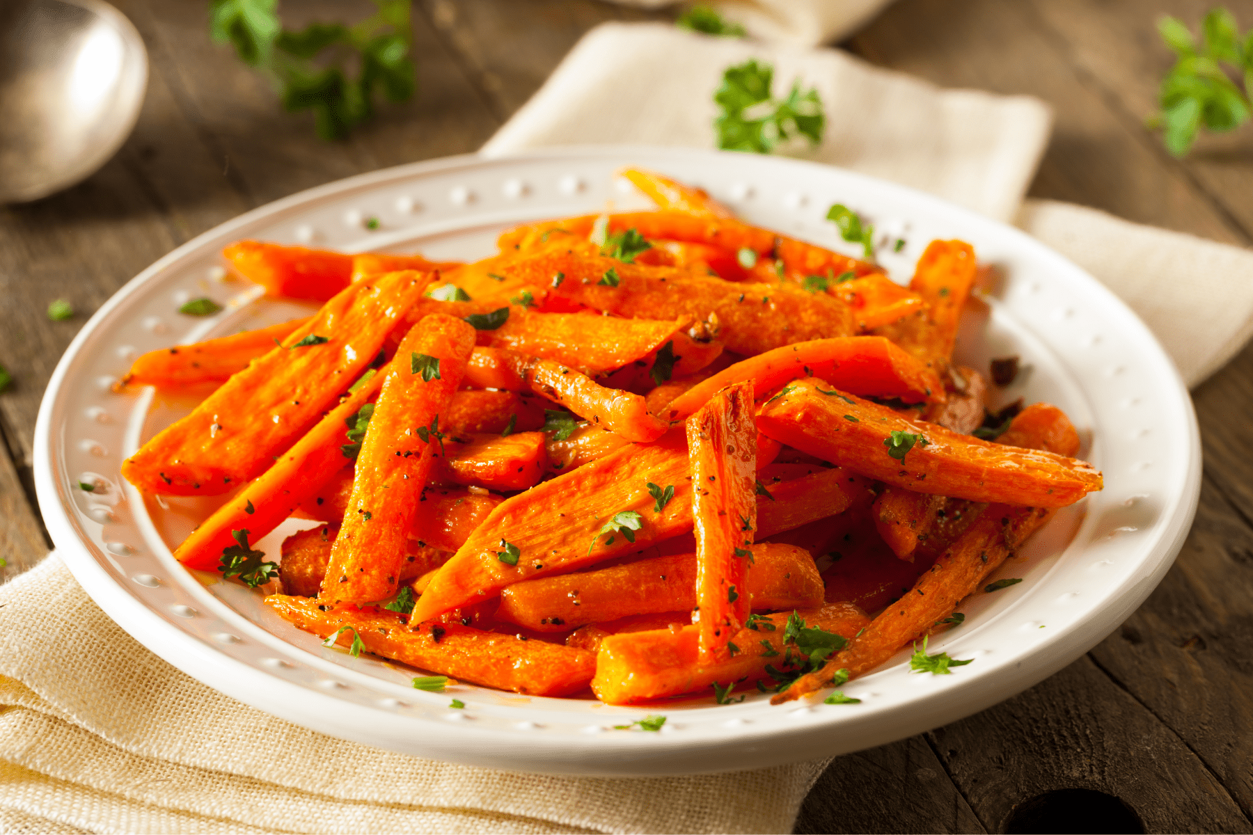 garlic parmesan roasted carrots in a white serving dish