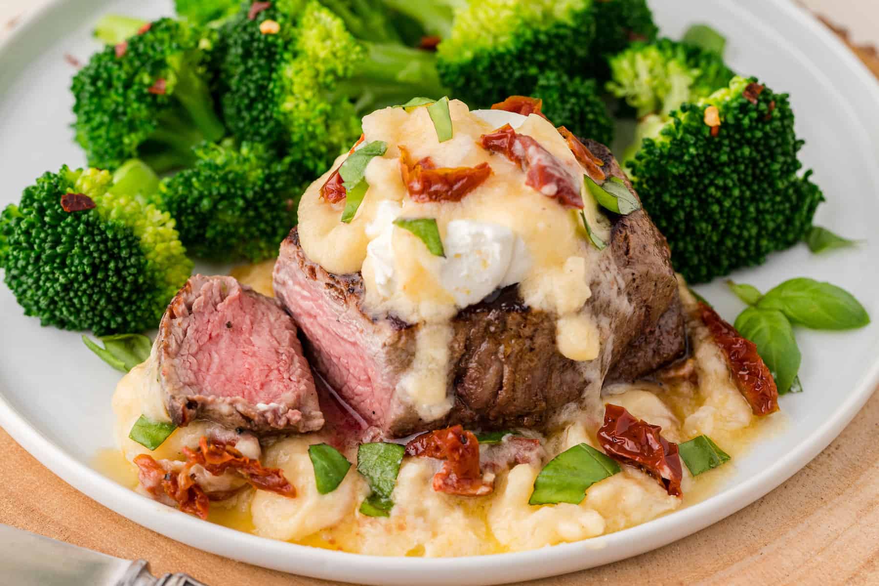 Carrabba's filet bryan on a plate with lemon butter sauce and broccoli