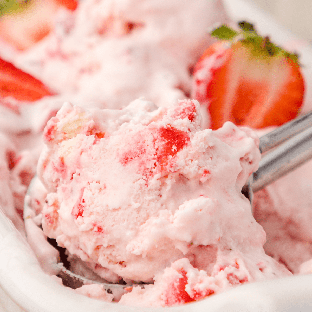 a close up of a scoop of strawberry cheesecake ice cream