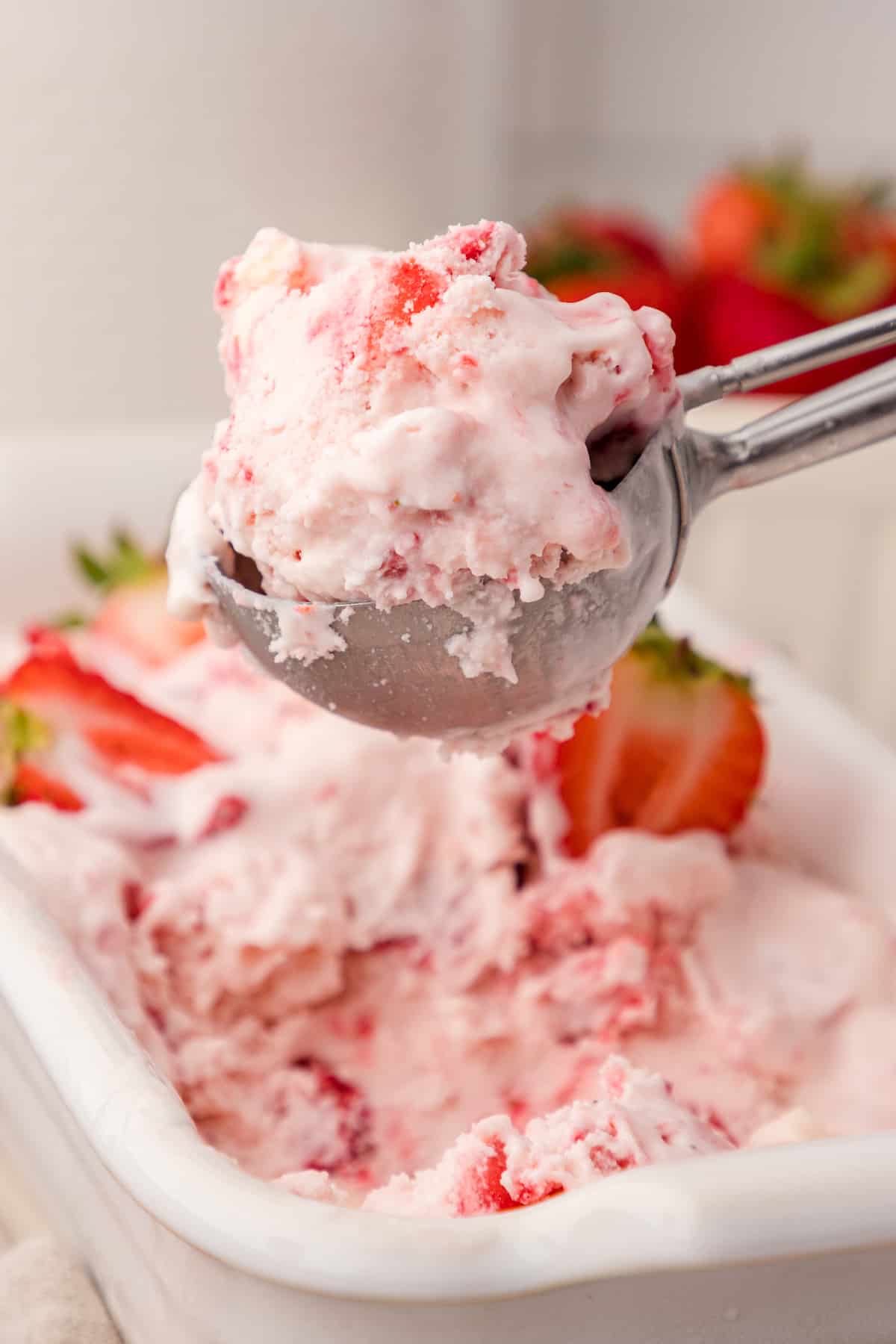 a close up of a scoop of strawberry cheesecake ice cream