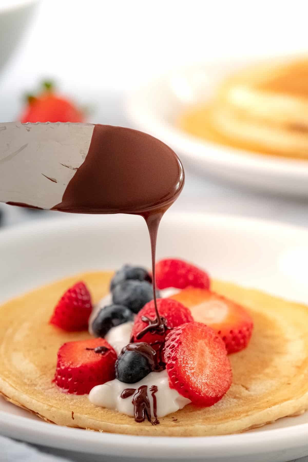 chocolate drizzle over a pancake taco with fruit and Greek yogurt