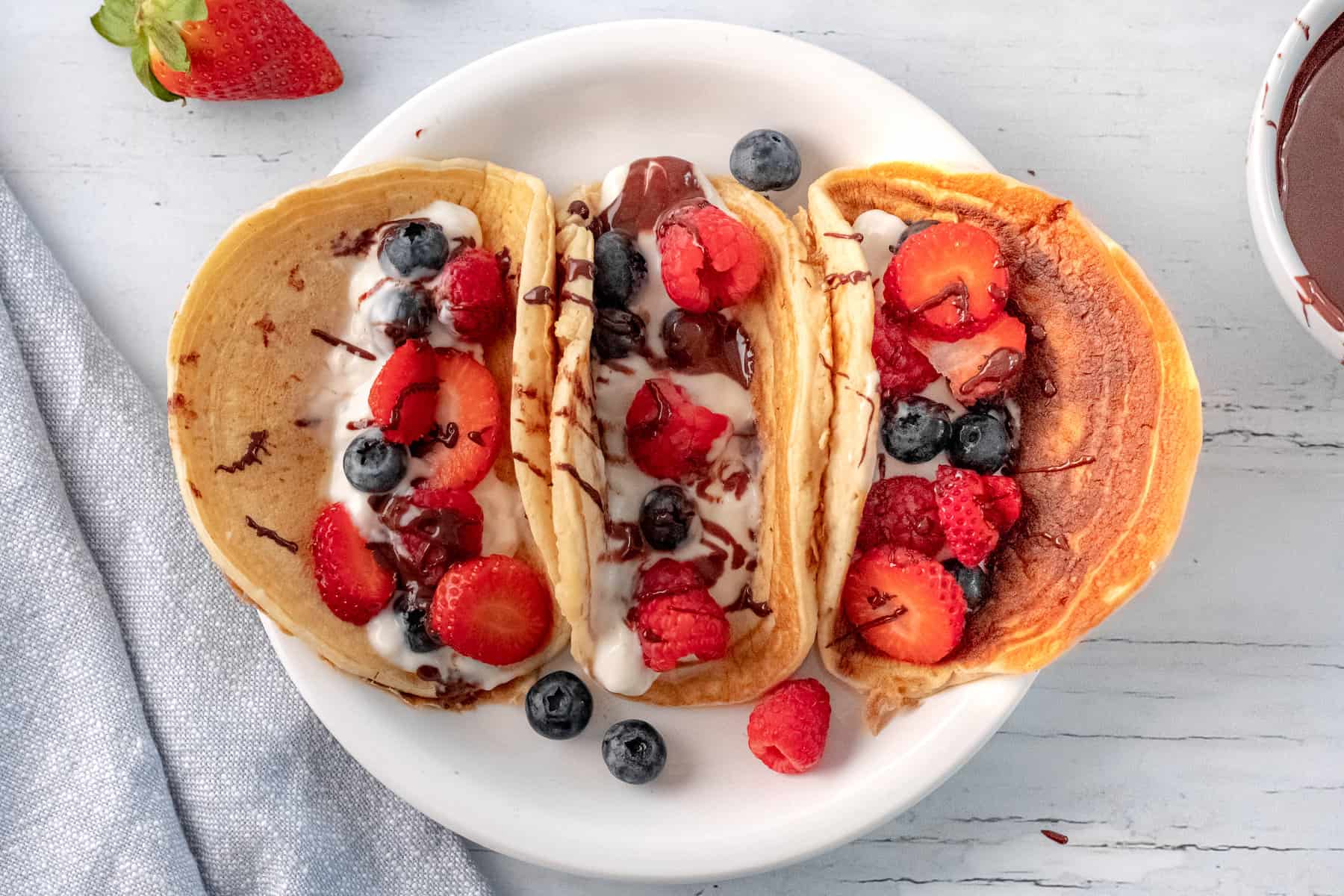 three pancake tacos with Greek yogurt and berries