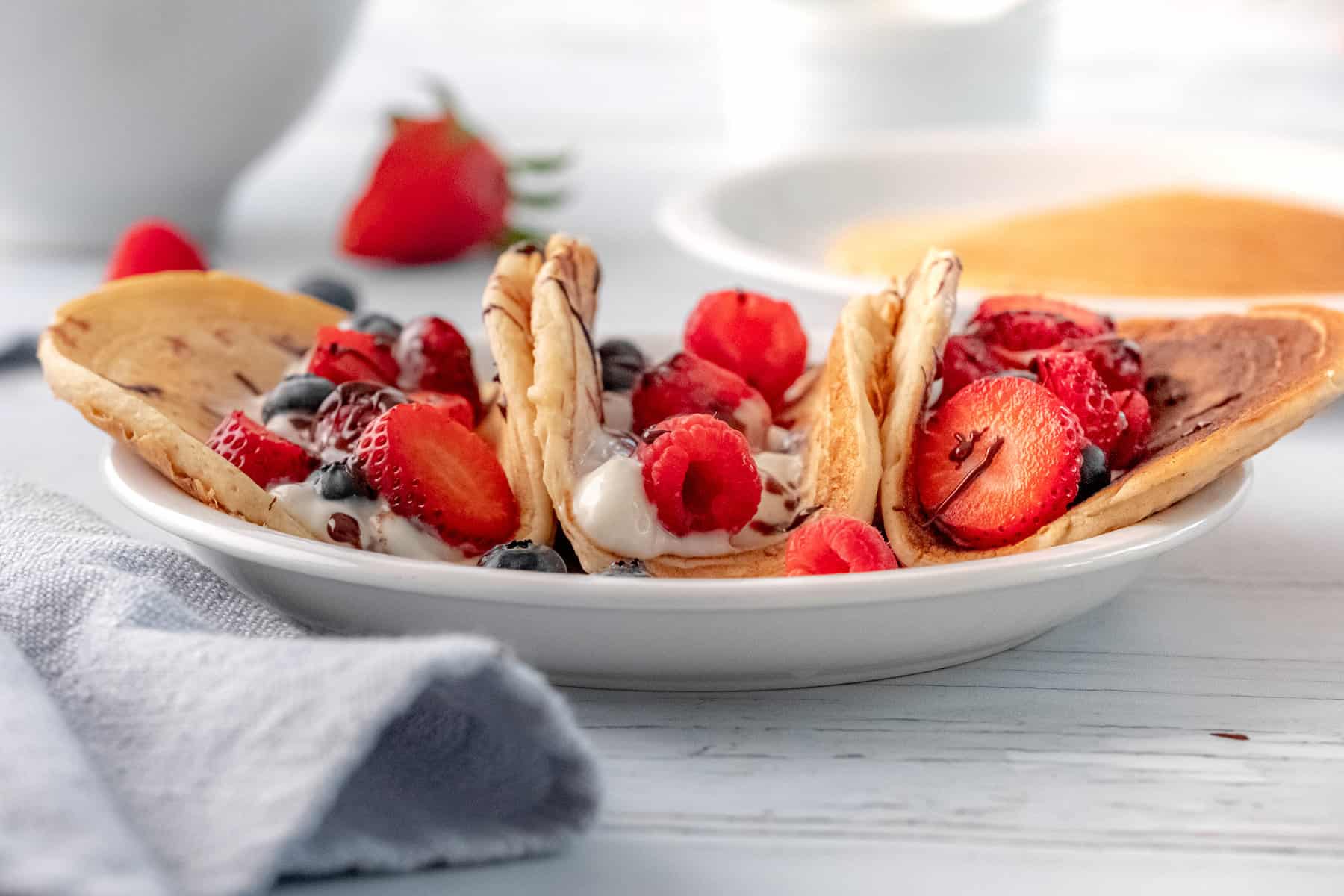 three pancake tacos with fruit and yogurt