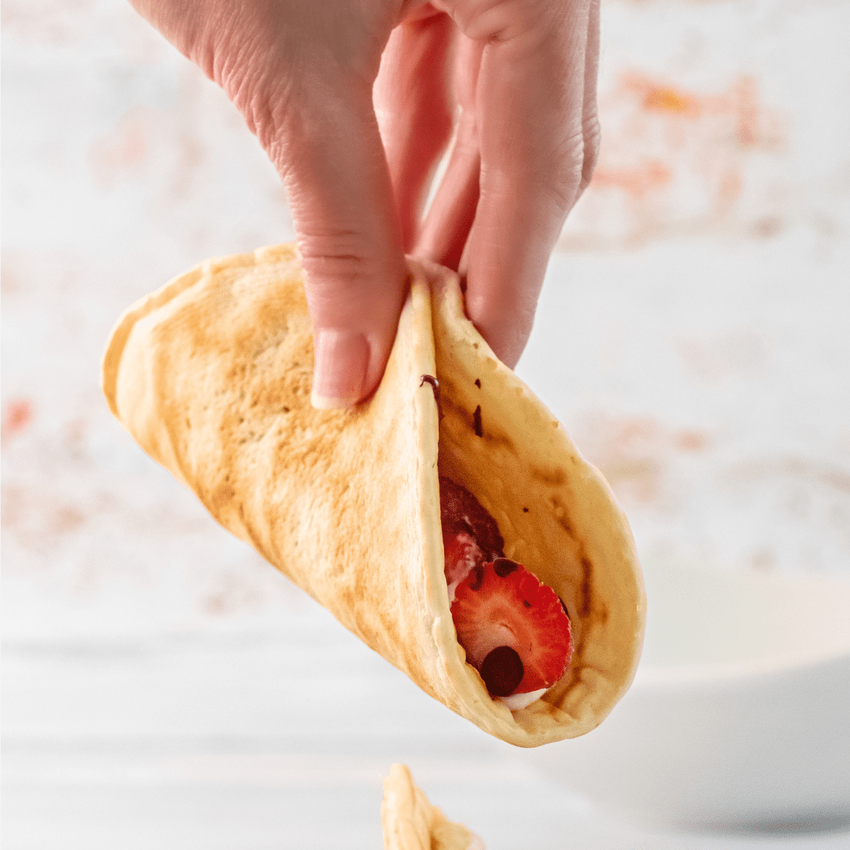 one pancake taco being held in a hand