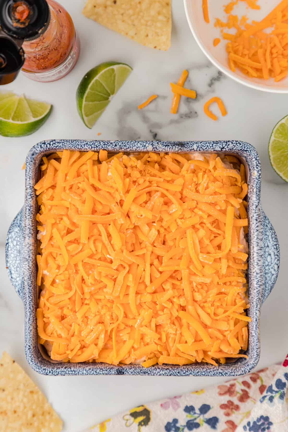 cover the dip with shredded cheddar cheese