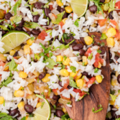 a close up of cilantro lime rice with black beans, corn, and tomatoes