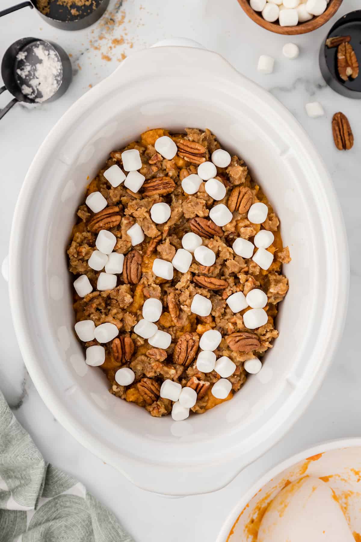 add marshmallows to the sweet potatoes in the crockpot