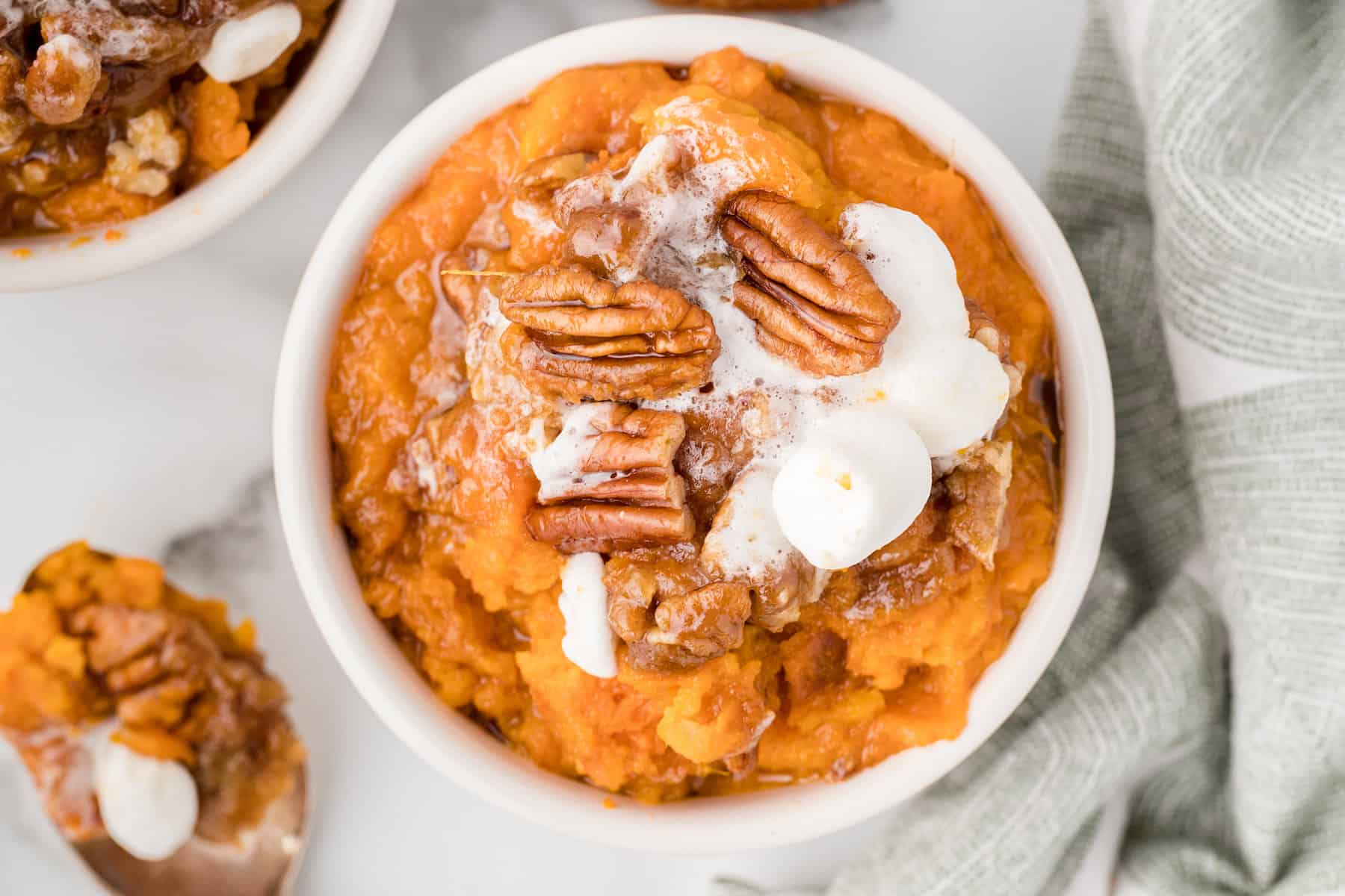 a serving of crockpot sweet potatoes in a white bowl