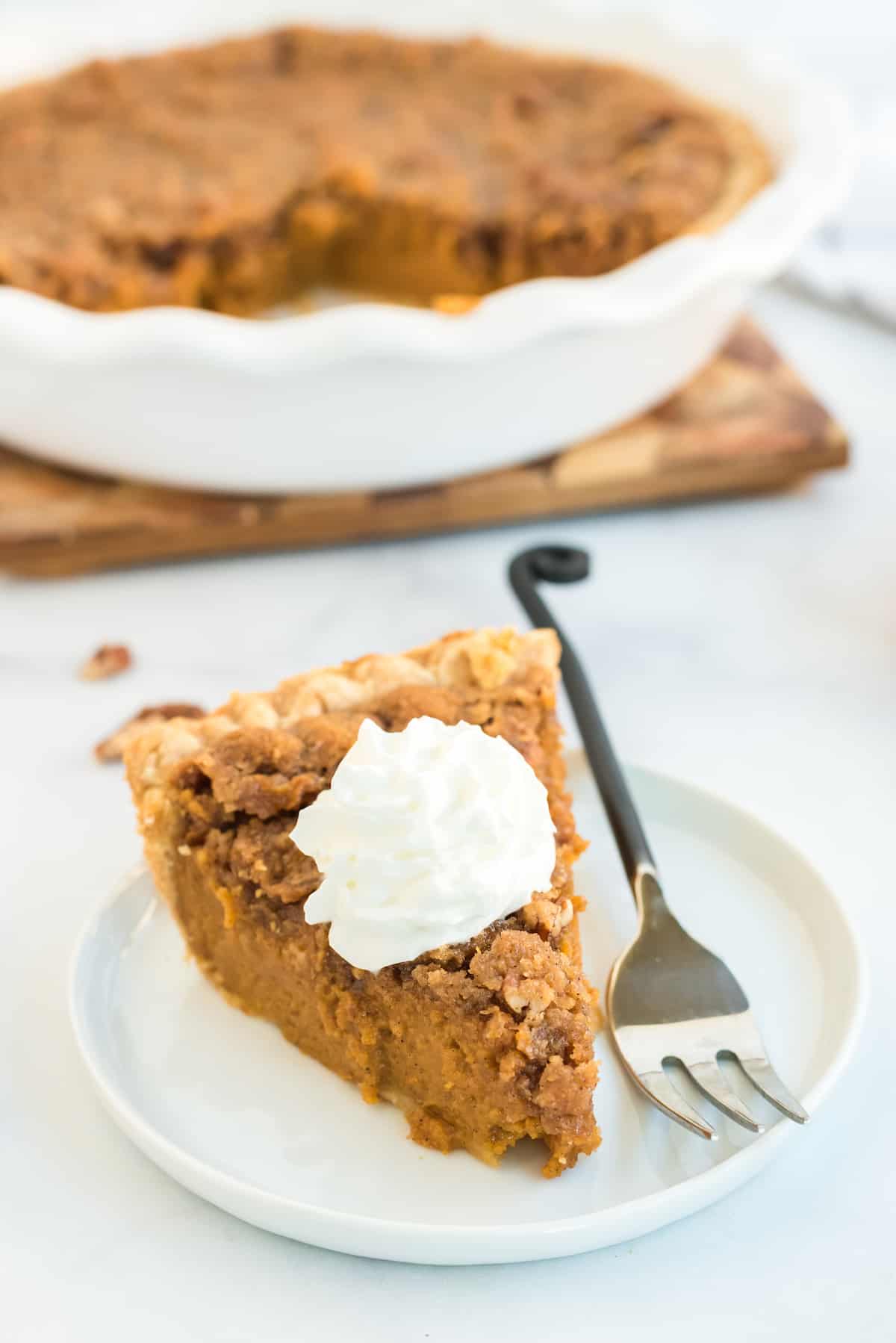 one slice of praline pumpkin pie with pecan topping