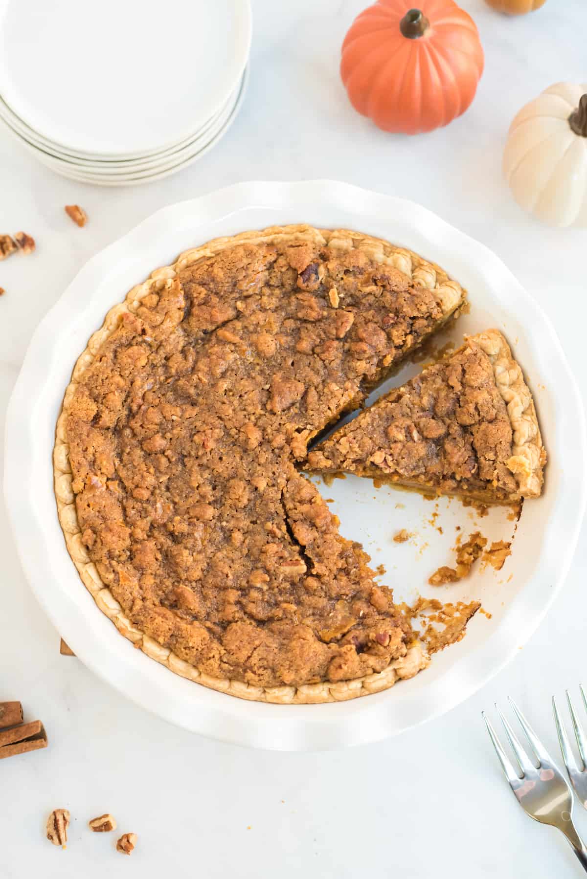 praline pumpkin pie with one slice removed