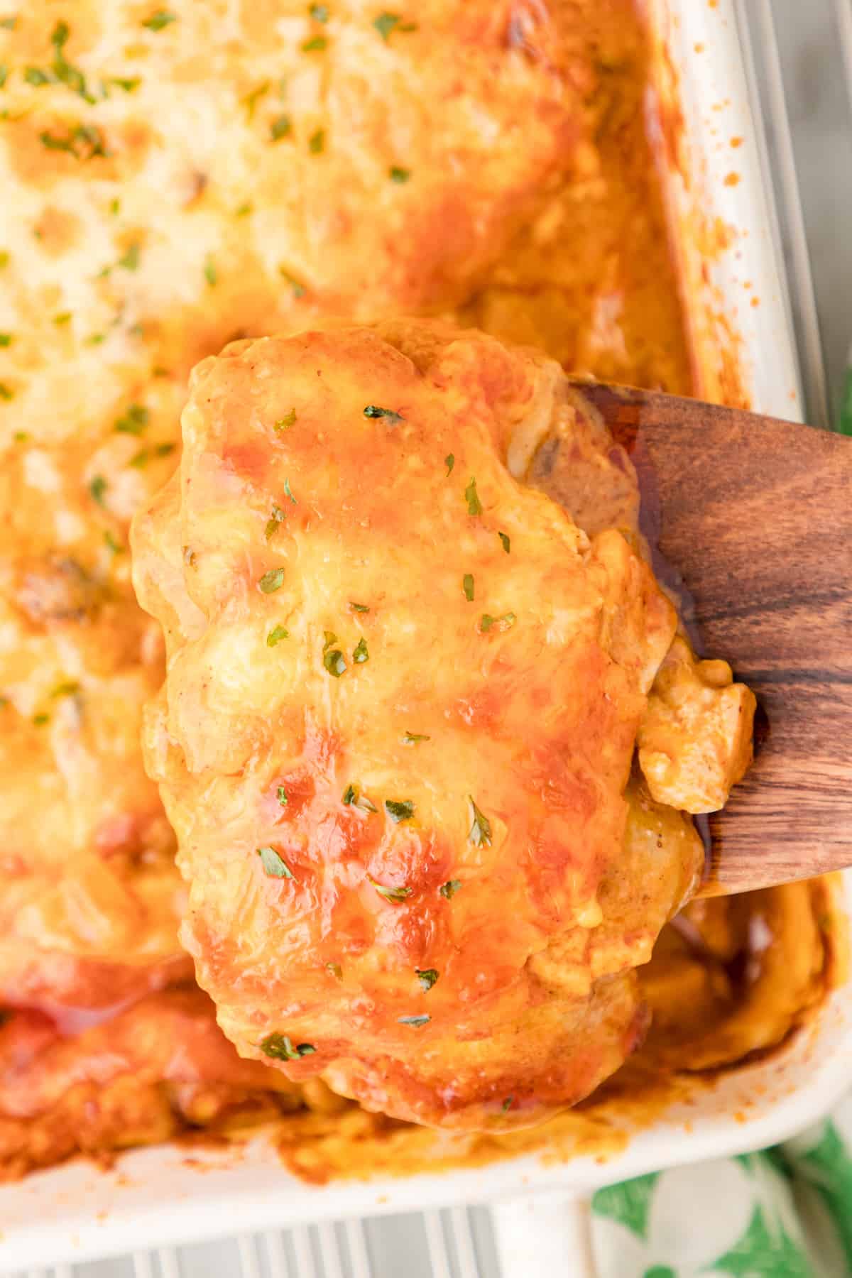 a serving of leftover turkey enchilada casserole on a spatula