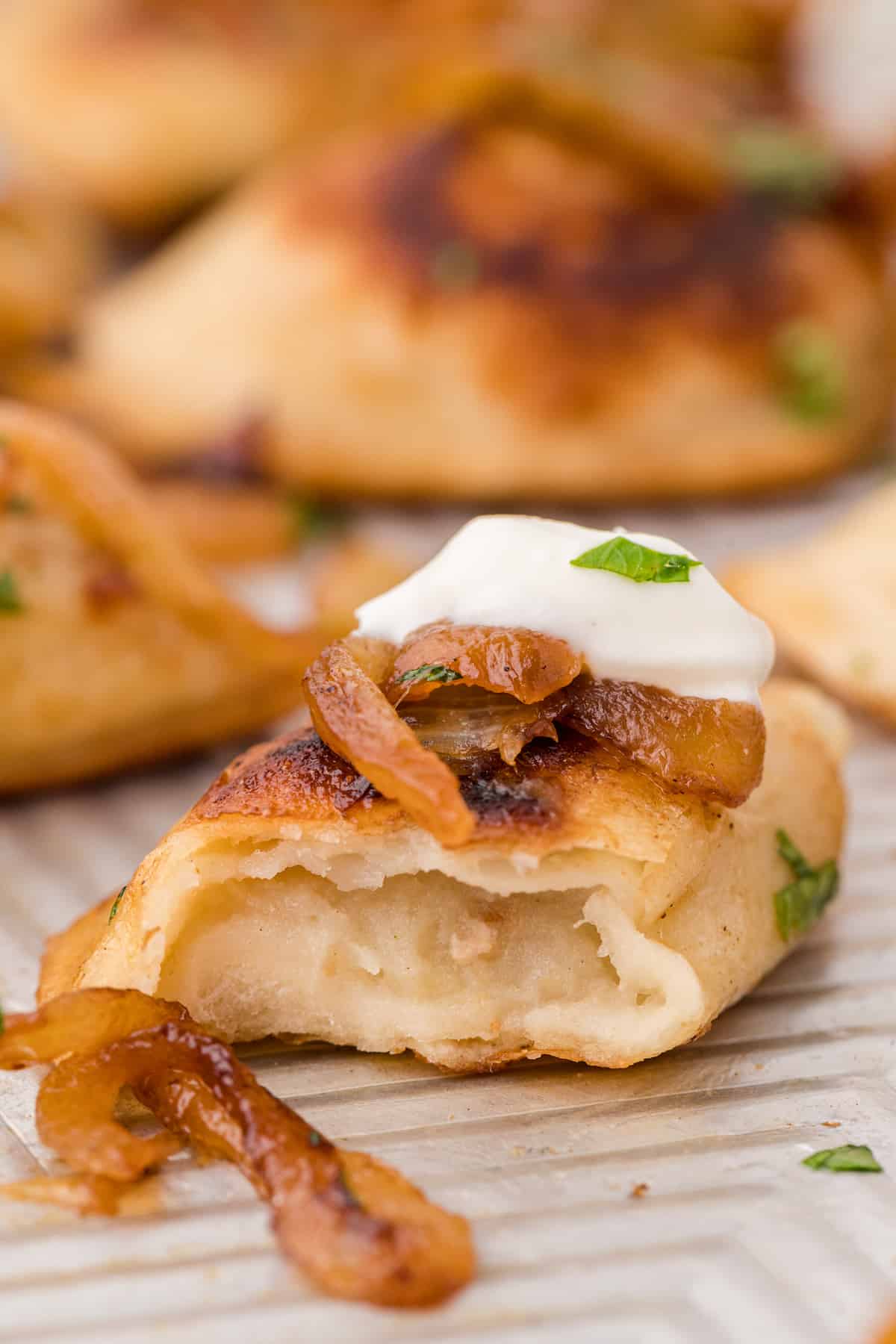 a pierogie with butter and onions cut in half