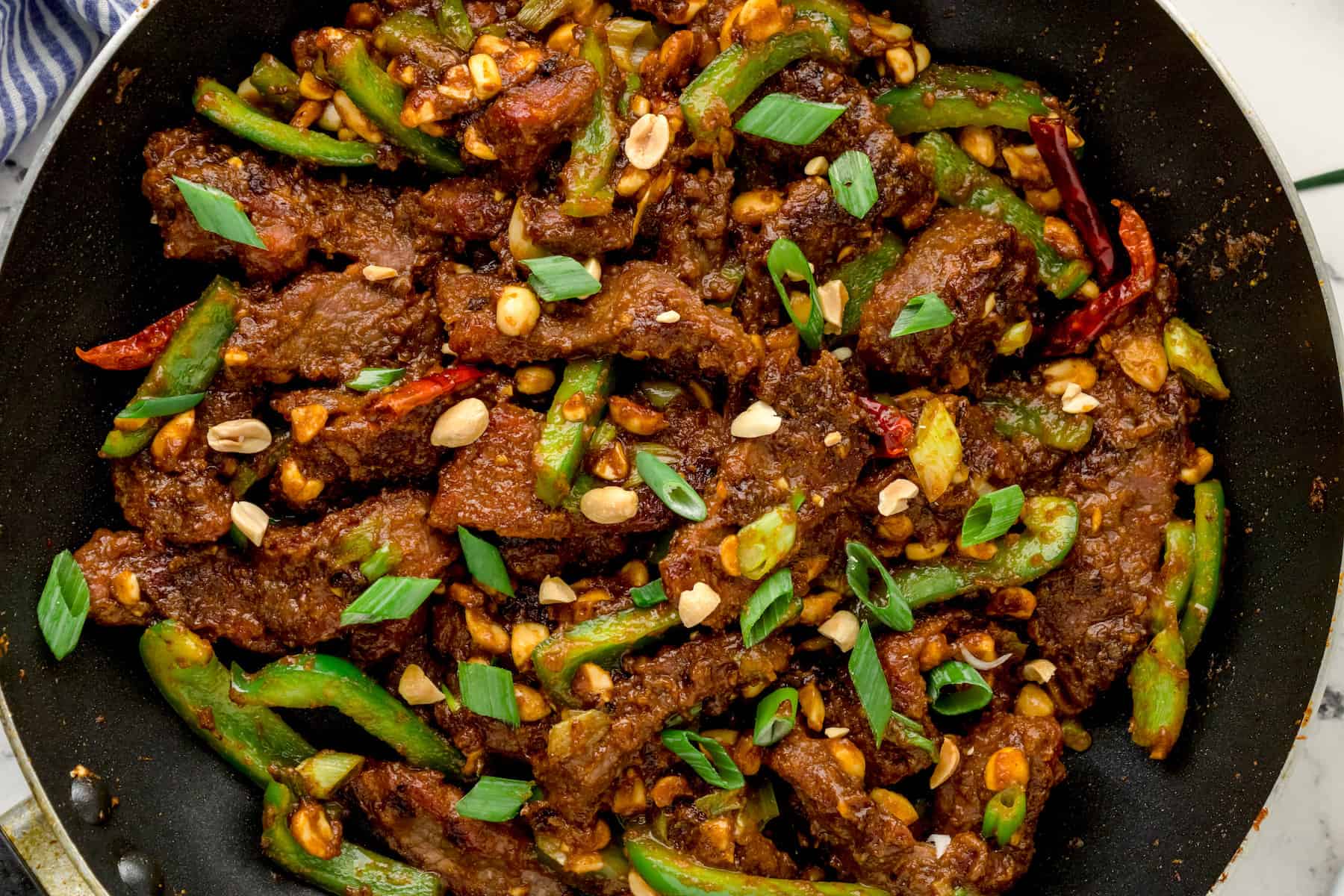 a close up of Kung Pao Beef in a black skillet