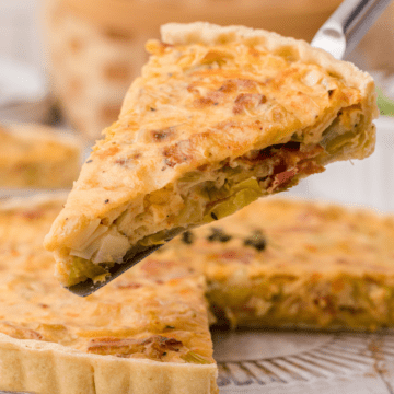 one slice of bacon leek tart with onions on a serving spatula