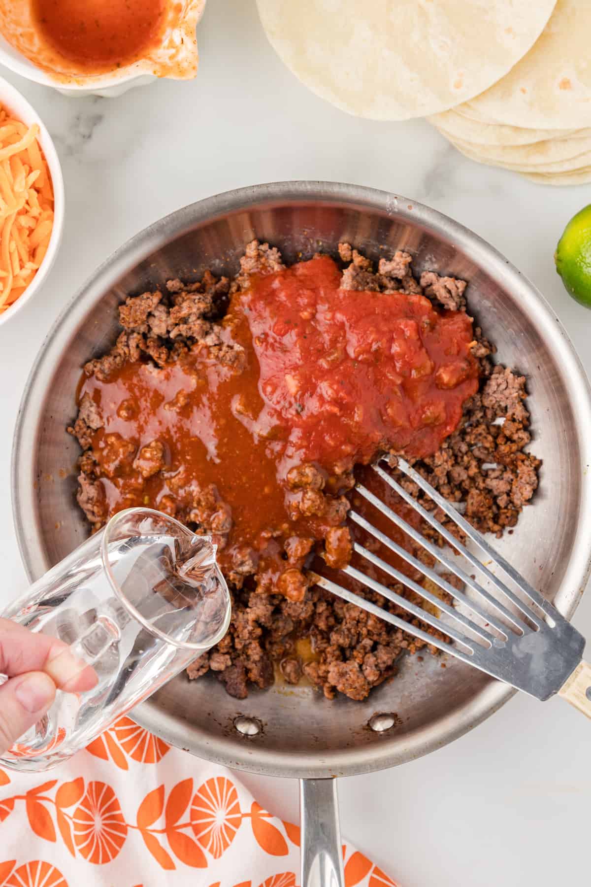add water to enchilada sauce and ground beef