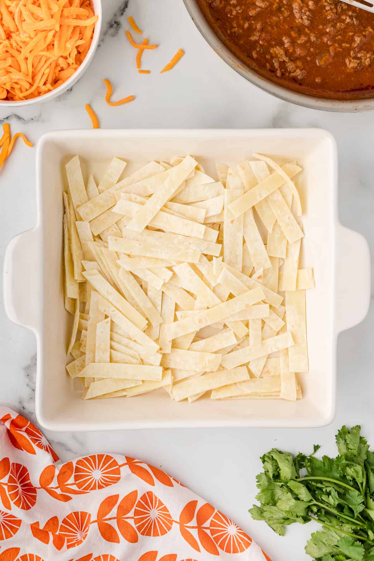 cover the baking dish with tortilla strips