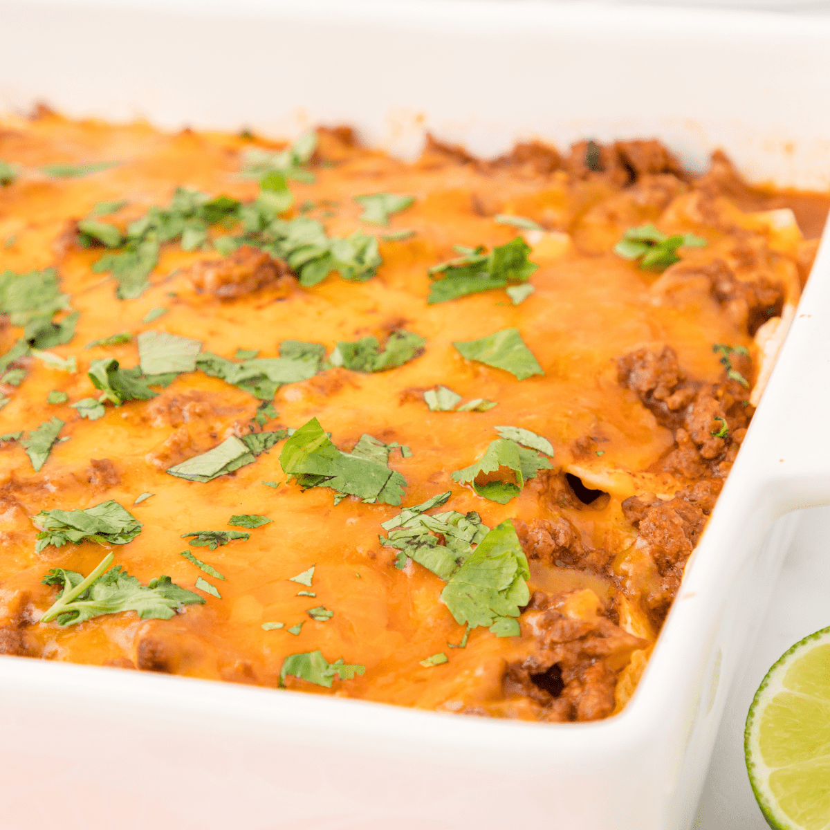 beef enchilada casserole in a white baking dish