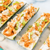 Buffalo Chicken Zucchini Boats with blue cheese crumbles, diced celery, and homemade ranch dressing