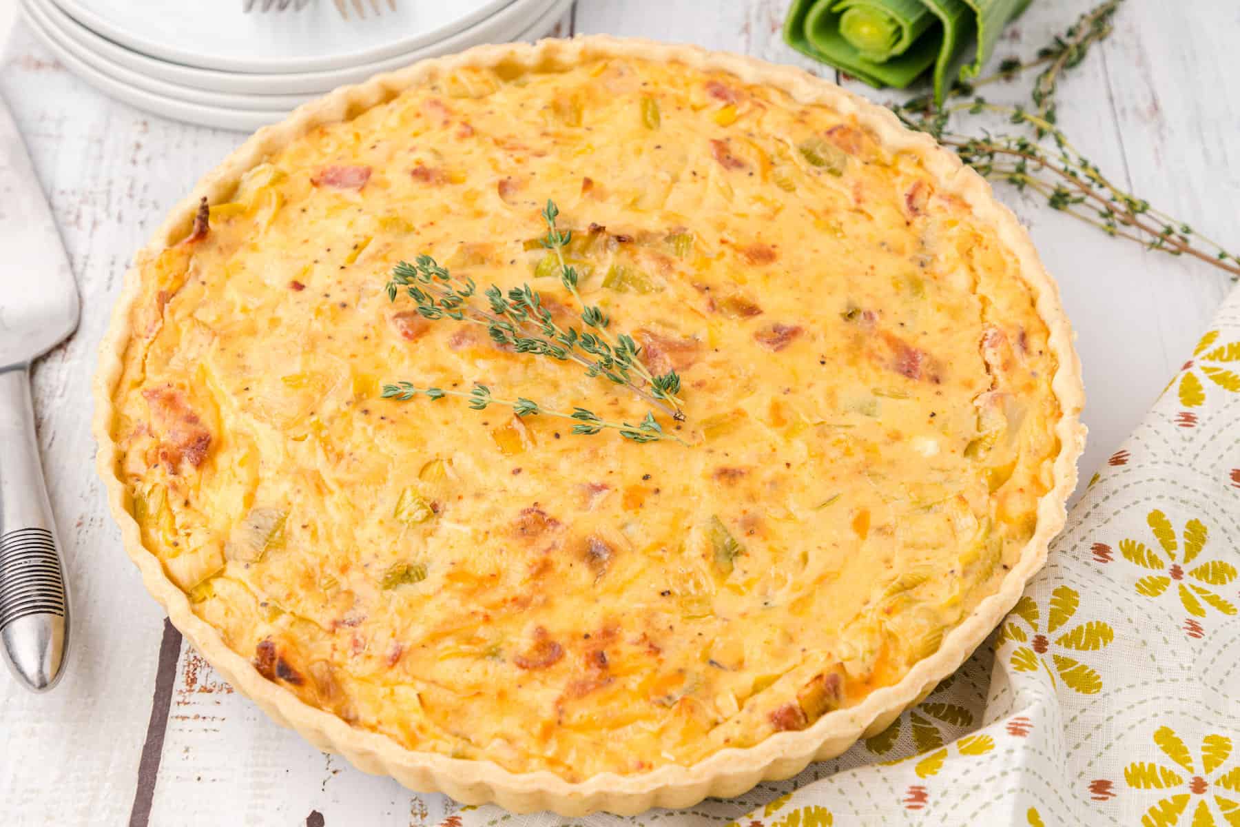 a whole bacon leek tart with onions with fresh thyme