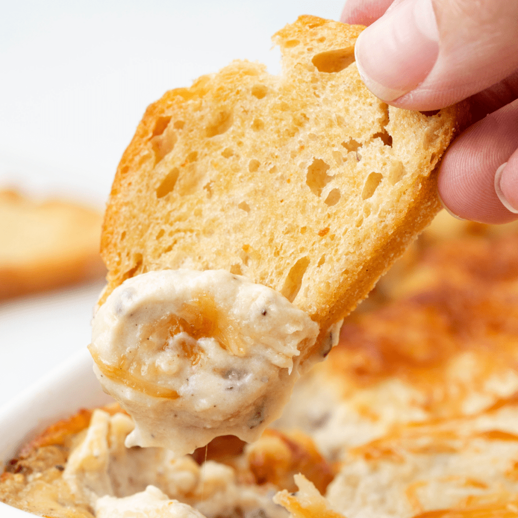 cream cheese garlic dip on a crostini