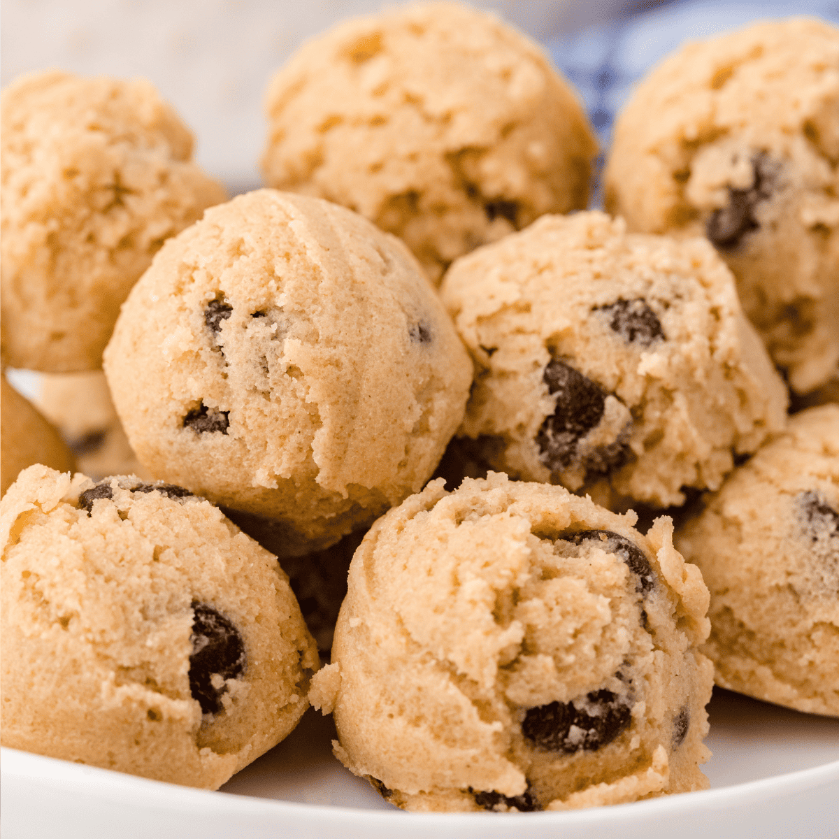 a close up of a plate full of Edible Chocolate Chip Cookie Dough Bites