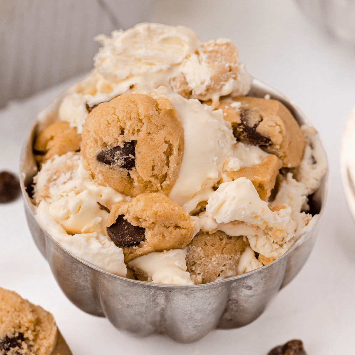 a metal bowl filled with cookie dough ice cream